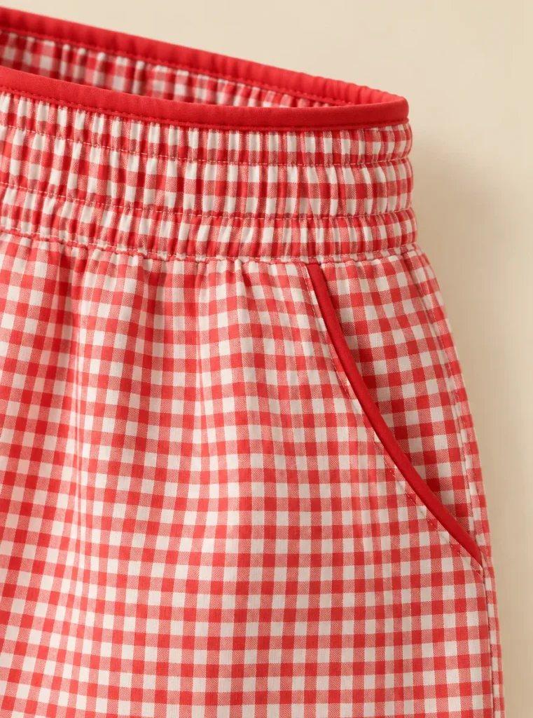 Close-up of the piping and construction on the Gingham Frill-Edge Short