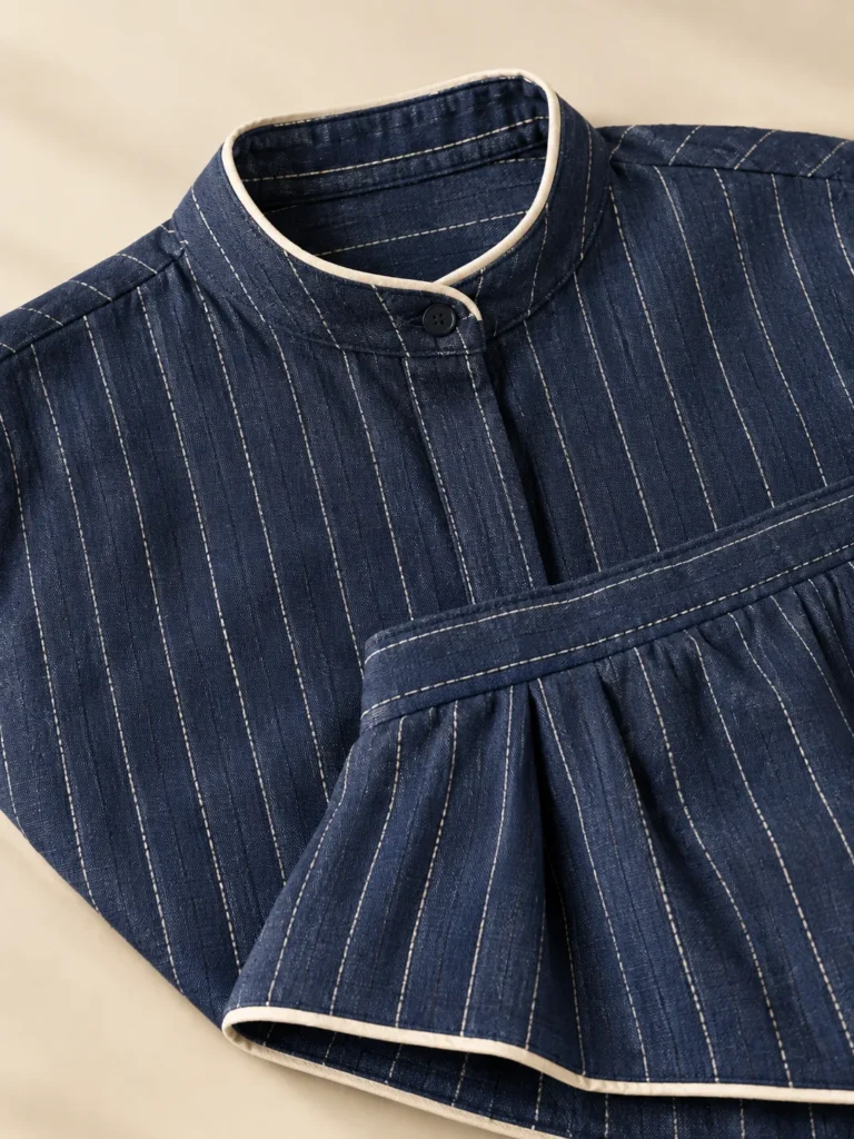 Close-up of the piping on the collar and shorts of the Navy Pinstripe Set